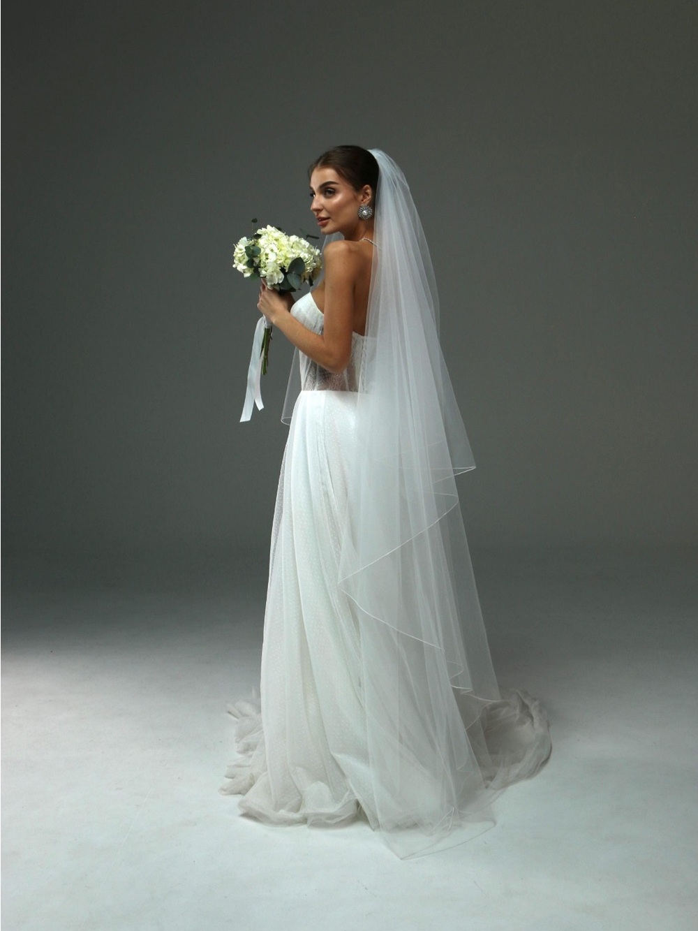 Classic White Strapless Bridal Gown with Veiled Overlay